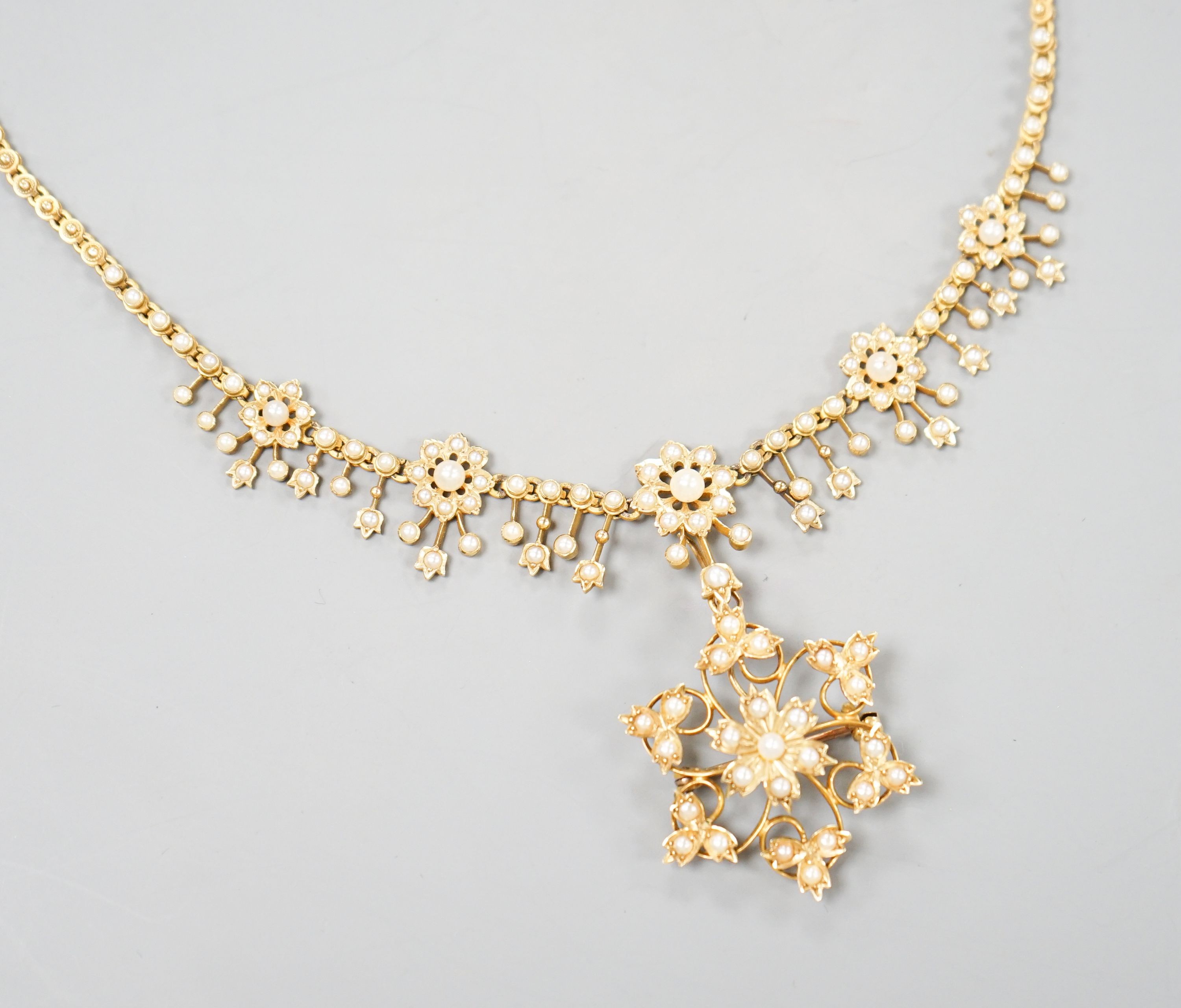 An Edwardian 15ct and seed pearl set pendant/brooch necklace, 44cm, gross weight 23.2 grams.